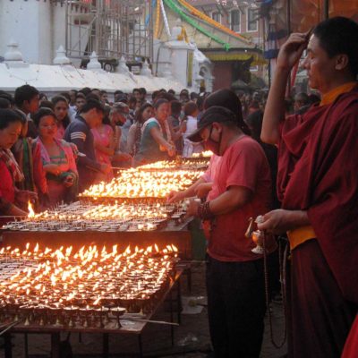 Lighting butterlamp for world peace in Kathamandu – lord Budda birthday
